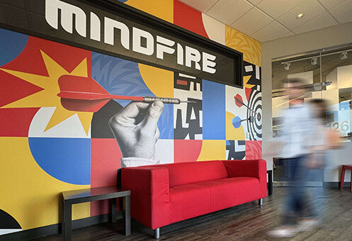 MindFire Communications lobby with red couch and person walking in foreground