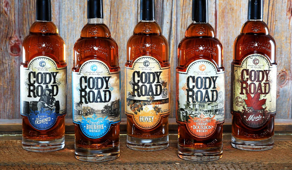 Five Cody Road bottles and labels in a line