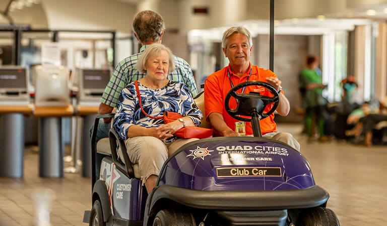 two people in cart in QCIA terminal