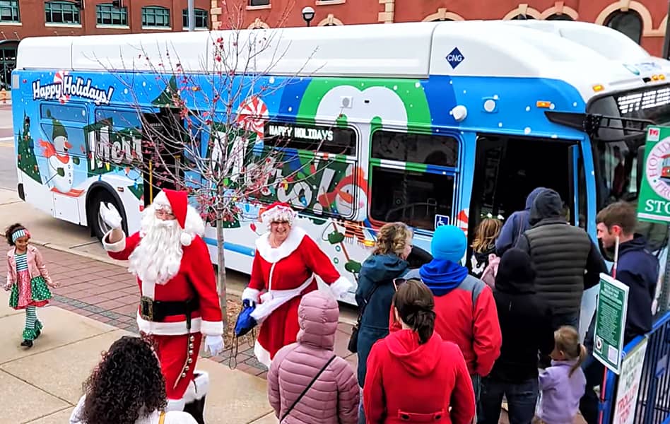 Santa and Ms. Clause stepping off MetroLINK bus